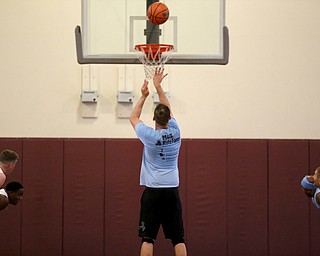 YPD Officer Mohammad Awad goes up for three during the Battle of the Blue charity basketball event benefiting the Mahoning County Children's Services, Friday, April 28, 2017 at the Arlington Heights Recreation Center in Youngstown. ..(Nikos Frazier | The Vindicator)..