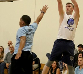 YFD firefighter Scott Barton goes up for three during the Battle of the Blue charity basketball event benefiting the Mahoning County Children's Services, Friday, April 28, 2017 at the Arlington Heights Recreation Center in Youngstown. ..(Nikos Frazier | The Vindicator)..