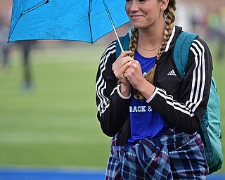 POLAND, OHIO - APRIL 29, 2017: Valley Christian's Tess Emerson stands under her umbrella as the rain starts to fall while watching the girls high jump, Saturday morning during the Poland Invitational at Poland High School. DAVID DERMER | THE VINDICATOR