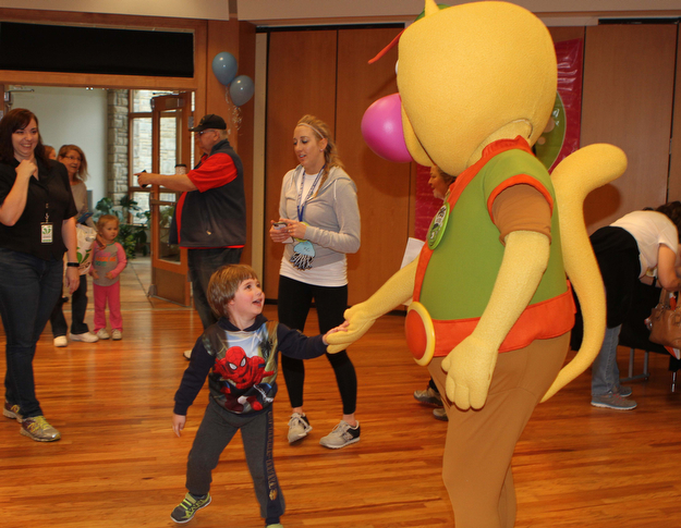 Joe Rimedio (4) of Austintown gives "Nature Cat" a high five during the "Plant a seed to Read" event at the Fellows Riverside Gardens of Mill Creek Park on Saturday morning.  Dustin Livesay  |  The Vindicator  4/29/17  Mill Creek Park.