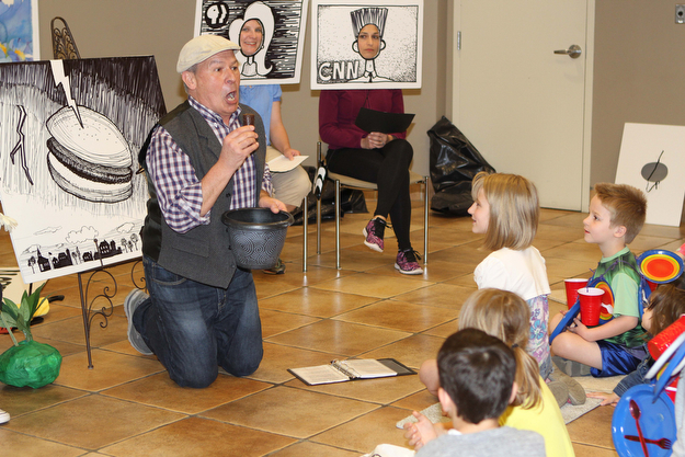 Storyteller Rick Schilling tells kids the story of "Cloudy with a chance of Meatballs" during the "Plant a seed to Read" event at the Fellows Riverside Gardens of Mill Creek Park on Saturday morning.  Dustin Livesay  |  The Vindicator  4/29/17  Mill Creek Park.
