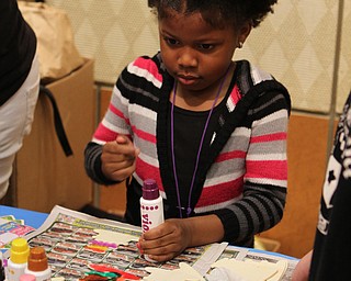 Tomorra Pollard (5) of Youngstown makes crafts during the "Plant a seed to Read" event at the Fellows Riverside Gardens of Mill Creek Park on Saturday morning.  Dustin Livesay  |  The Vindicator  4/29/17  Mill Creek Park.