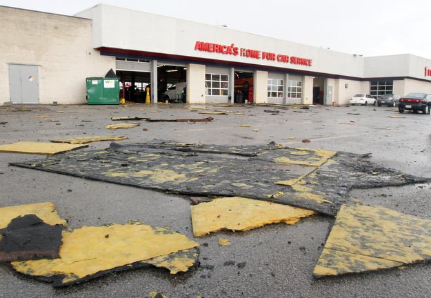 william d Lewis the vindicator A fast movinf storm packing strong winds and heavy rain tore part of the roof off the Firtestone Store at the Southern Park Mall Sunday April 30, 1017. Several nearby cars were damagd by debris from  the roof.