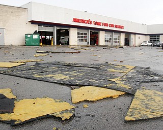 william d Lewis the vindicator A fast movinf storm packing strong winds and heavy rain tore part of the roof off the Firtestone Store at the Southern Park Mall Sunday April 30, 1017. Several nearby cars were damagd by debris from the roof.
