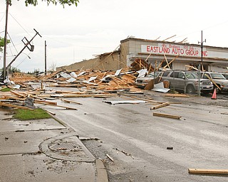        ROBERT K. YOSAY  | THE VINDICATO..An early afternoon storm -  Six Brothers Eastland Auto Sales on Oak Street.. lost its roof..