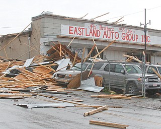        ROBERT K. YOSAY  | THE VINDICATO..An early afternoon storm -  Six Brothers Eastland Auto Sales on Oak Street.. lost its roof..