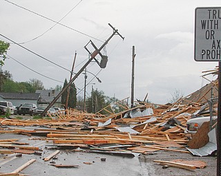        ROBERT K. YOSAY  | THE VINDICATO..An early afternoon storm -  Six Brothers Eastland Auto Sales on Oak Street.. lost its roof..