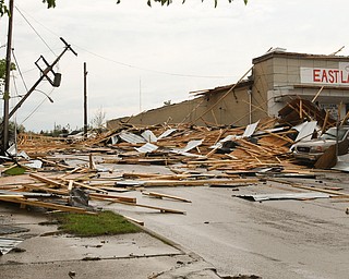        ROBERT K. YOSAY  | THE VINDICATO..An early afternoon storm -  Six Brothers Eastland Auto Sales on Oak Street.. lost its roof..