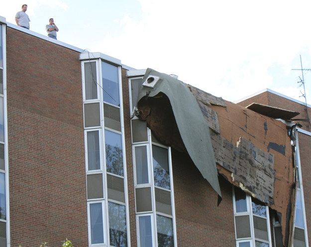 William D. Lewis The vindicator   Workers survey damage to roof of PArk Vista building on Fifth Ave in Youngstown 5-1-17. a late afternoon storm ripped part of the roof from the building.