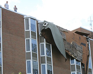William D. Lewis The vindicator   Workers survey damage to roof of PArk Vista building on Fifth Ave in Youngstown 5-1-17. a late afternoon storm ripped part of the roof from the building.