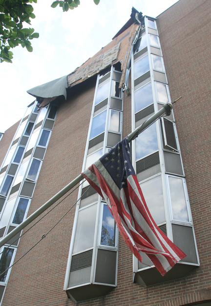 William D. Lewis The vindicator  A tattered American Flag on a damaged flag pole flies at Park Vista building on Fifth Ave in Youngstown 5-1-17. a late afternoon storm ripped part of the roof from the building.