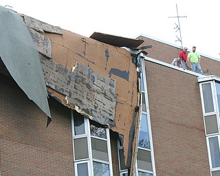 William D. Lewis The vindicator   Workers survey damage to roof of PArk Vista building on Fifth Ave in Youngstown 5-1-17. a late afternoon storm ripped part of the roof from the building.