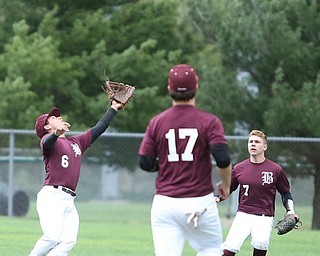 Boardman outfielder Alex Cordona(6) reaches out for the ball as Don Stilliana(7) and first baseman Evan Kraus(17) watch on during the 1st inning as Boardman takes on Poland, Tuesday, May 2, 2017 at Cene Park. ..(Nikos Frazier | The Vindicator)..