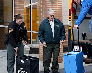 Joe Aless(center left) hands off his ballot boxes to Board of Election Officials at St. Christine Parish Center, Tuesday, May 2, 2017 in Youngstown. ..(Nikos Frazier | The Vindicator)..Offcials: Deputy Stephanie Harchar, Nick Sharpe(blue).