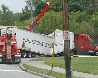        ROBERT K. YOSAY  | THE VINDICATOR..Tow trucks try to straighten and lift  a trailer just off Oak Hill after the truck tried to get under the railroad bridge at Oak Hill and Marshall...