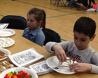 SPECIAL TO THE VINDICATOR
Damascus Elementary in Beloit hosted a family fun and learning night March 28 in partnership with the University of Mount Union. University students set up science activity stations for kindergarten and first grade students, including making edible solar systems, performing a letter archaeological dig, playing matching games and learning about dinosaurs and underwater sea creatures. Elementary students, above from left, are Alexis Klemann and Giancarlo Corallo. Below is Tianna Mitchell.