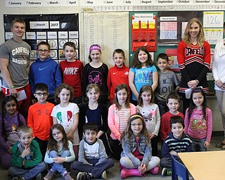 Neighbors | Abby Slanker.Heather Bruno’s first-grade class at C.H. Campbell Elementary School welcomed Canfield High School sophomore football player, basketball player and track team member Colin Hritz, (back, left) and senior varsity basketball cheerleader Katie Gamble (back, right) to the school’s annual Read-a-Thon on March 20.