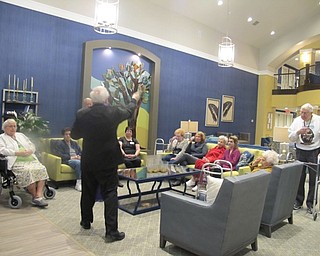 Neighbors | Alexis Bartolomucci.Monsignor William J. Connell used holy water to bless the different areas at the Inn at Poland Way on April 7.