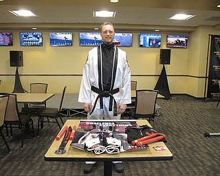 Neighbors | Alexis Bartolomucci.Jasen Pekalla, co-owner and trainer at ATA Martial Arts, set up a table and will be putting on demonstrations for the Youngstown Fitness Expo on May 13.