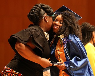 Precious Brown hugs Dean Monica Jones after receiving her high school diploma from Youngstown Early College graduation at Ford Recital Hall at DeYor Performing Arts Center, Sunday, May 7, 2017 in Youngstown. ..(Nikos Frazier | The Vindicator)