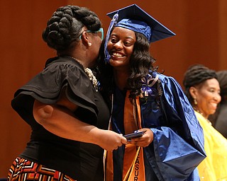 Khiara Price hugs Dean Monica Jones after receiving her high school diploma from Youngstown Early College graduation at Ford Recital Hall at DeYor Performing Arts Center, Sunday, May 7, 2017 in Youngstown. ..(Nikos Frazier | The Vindicator)