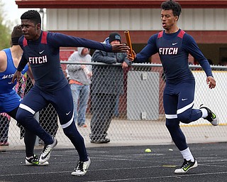MICHAEL G TAYLOR | THE VINDICATOR- 05-06-17  37th Annual Optimist High School Invitational Track Meet in Austintown, OH at Austintown High School.  Austintown's Drew Bretsik passes the batton to his teammate Ralph Fitzgerald during Austintown's winning 4x100m relay race.