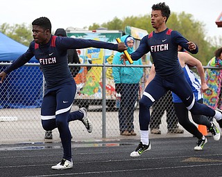 MICHAEL G TAYLOR | THE VINDICATOR- 05-06-17  37th Annual Optimist High School Invitational Track Meet in Austintown, OH at Austintown High School.  Austintown's Drew Bretsik passes the batton to his teammate Ralph Fitzgerald during Austintown's winning 4x100m relay race.