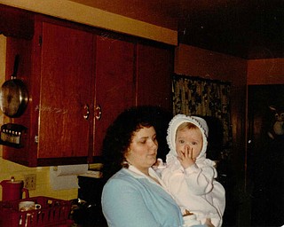 Peggy Brewer of Girard, holds her daughter, Lisa Kuty, also of Girard, as a toddler.