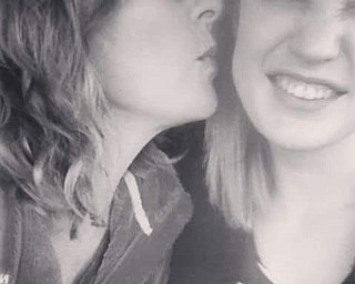 Sandi Weigle of East Palestine shows her affection for daughter Nicole Weigle, also of East Palestine.