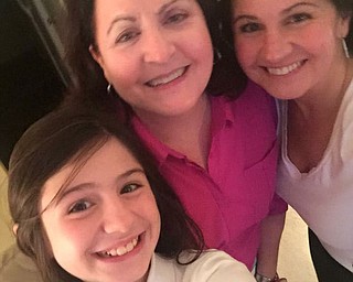 Grandmother Mary Lou Savon is hugged by daughter Jen Cline and granddaughter Bree Latell. All are from Boardman.