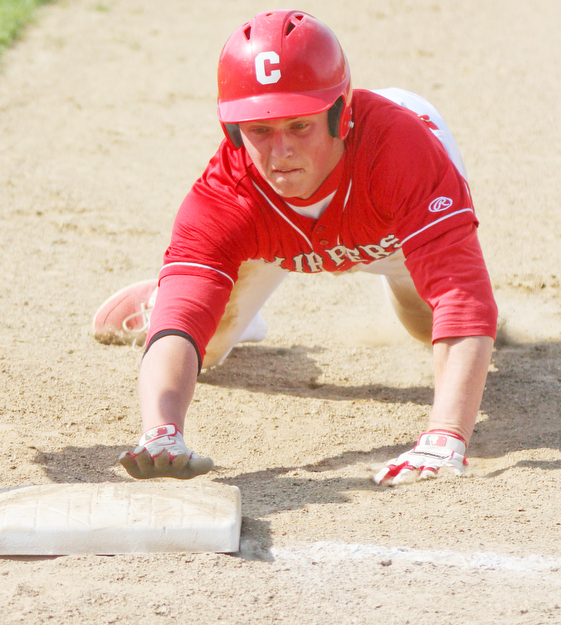 William D Lewis The Vindicator  Columbiana's Keenan Green(8) dives back to first during a pickoff attempt during 5-10-17 game with Crestview.