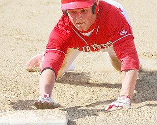 William D Lewis The Vindicator Columbiana's Keenan Green(8) dives back to first during a pickoff attempt during 5-10-17 game with Crestview.