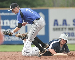 William D. Lewis The Vindicator Jackson Milton Eric Ostrowski(7) tries to make the tag as Lowellville's Anthony PetosvichCK SPELLING (44) gets back to second during 5-11-17 game.