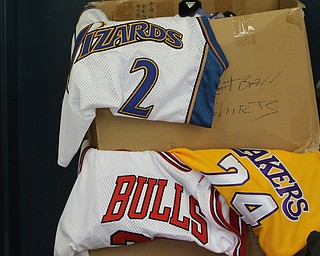        ROBERT K. YOSAY  | THE VINDICATOR..Items confiscated from a ring dealing in fraudulent sports memorabilia will find a second life in the hands of local kids in need according to Canfield