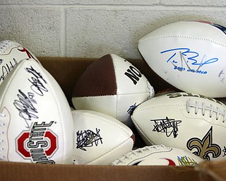        ROBERT K. YOSAY  | THE VINDICATOR..Items confiscated from a ring dealing in fraudulent sports memorabilia will find a second life in the hands of local kids in need according to Canfield