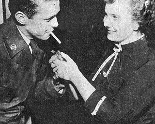 Vindicator file photo | May 16, 1954A good deal of the credit for the exceptionally high morale and fine records at the Air Force‚Äôs jet air base at the Youngstown Municipal Airport can go to the Youngstown -Mahoning County USO Committee which has gone all out to keep the enllisted men entertained with weekly dances, dinners and other entertainment. Most popular is the junior hostess program sponsored jointly with with YWCA and and the recent dance brought out the enlisted men in droves to dance with pretty girls, watch a floor show and enjoy a midnight snack. Above, Three hands are better than one in lighting a cigarette as demonstrated by A2C Harry Schroaeder and Virginia Smith.