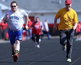 MICHAEL G TAYLOR | THE VINDICATOR- 05-13-17 Special Olympics 8th Annual Trumbull County Invitational at Arrowhead Stadium, Girard High School in Girard, OH.  .Opening cermony, Trumbull County Special Olympics, Fairhaven Bulldogs team member, Aaron Plummer (left) and Alan Frederick, Ashtabula County Special Olympics, compete in the 100m run.