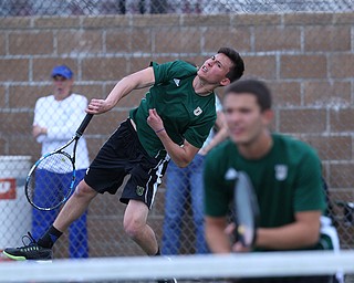MICHAEL G TAYLOR | THE VINDICATOR- 05-13-17  Tennis -  D2 Tennis Sectional at Boardman High School in Boardman, OH.During the 2nd set of their doubles match, Ursuline's Austin Arfaras powers in a serve. Ursuline won the sectional title over Poland.