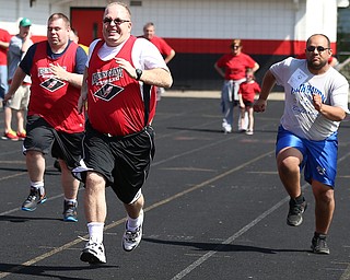 MICHAEL G TAYLOR | THE VINDICATOR- 05-13-17 Special Olympics 8th Annual Trumbull County Invitational at Arrowhead Stadium, Girard High School in Girard, OH.  .Opening cermony, Mahoning County Special Olympics team member, Michael Jubak (leading) competes in the 100m run