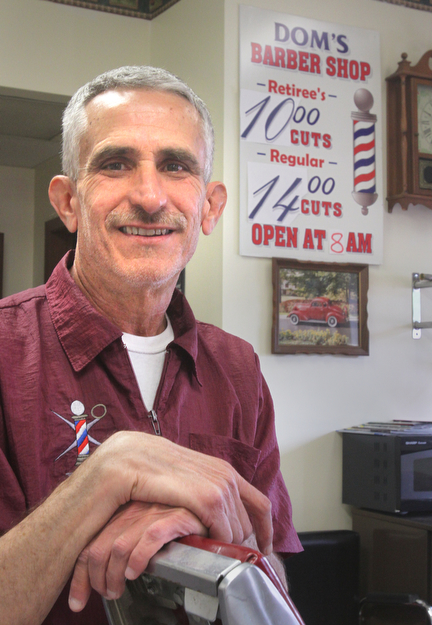 William D. Lewis The Vindicator Barber Bob Leonelli shares a laugh as he talks about nostalgic decor in his Boardman barbershop.