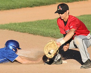 William D. Lewis The Vindicator  Poland's Ian Lu(5) dives back to first as Canfield'sSpencer Woolley(2) waits for the throw during 5-15-17 game at cene..