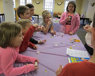 Neighbors | Alexis Bartolomucci.Children felt the inside of their marshmallows to see how sticky they were and to see if they could make them not sticky for the Sweet Science program at the Poland library.