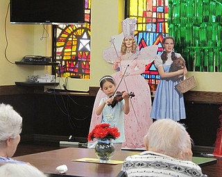 Neighbors | Alexis Bartolomucci.Lydia played the violin before the Oakland Center for the Arts cast performed "The Wizard of Oz" for the residents of Shepherd of the Valley Boardman on April 20.