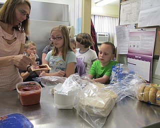 Neighbors | Alexis Bartolomucci.Students at Market Street Elementary waited in line to make their own pizzas during the Tot Chef program on April 27.