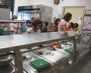 Neighbors | Alexis Bartolomucci.Market Street Elementary students walked through the line adding toppings to their pizzas on April 27 for the Tot Chef program.