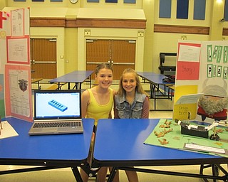 Neighbors | Alexis Bartolomucci.Austintown Middle School STEM students, Maryn and Kristin, sat next to their projects during the STEM Showcase.