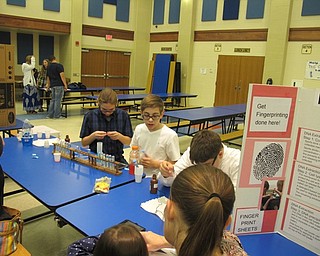 Neighbors | Alexis Bartolomuccis.Austintown Middle School STEM students offered fingerprinting to the guests at the STEM Showcase on May 4.