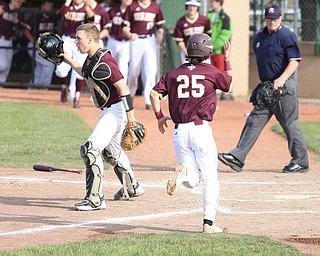Walsh runner Brendan Regan(25) runs towards his teammates after a run as Boardman catcher Coleman Stauffer(20) walks towards the pitchers mound  during the 4th inning as the Boardman takes on Walsh Jesuit in the Division I District final, Friday, May 19, 2017 at Bob Cene Park in Struthers...(Nikos Frazier | The Vindicator)..
