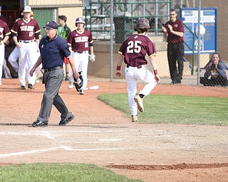 Walsh runner Brendan Regan(25) runs towards his teammates after a run as Boardman catcher Coleman Stauffer(20) walks towards the pitchers mound  during the 4th inning as the Boardman takes on Walsh Jesuit in the Division I District final, Friday, May 19, 2017 at Bob Cene Park in Struthers...(Nikos Frazier | The Vindicator)..