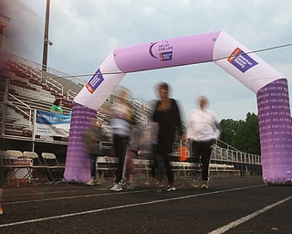 A long exposure showing groups walking under the Relay for Life Sign during the Relay for Life event at Boardman Spartan Stadium, Friday, May 19, 2017 in Boardman. ..(Nikos Frazier | The Vindicator)